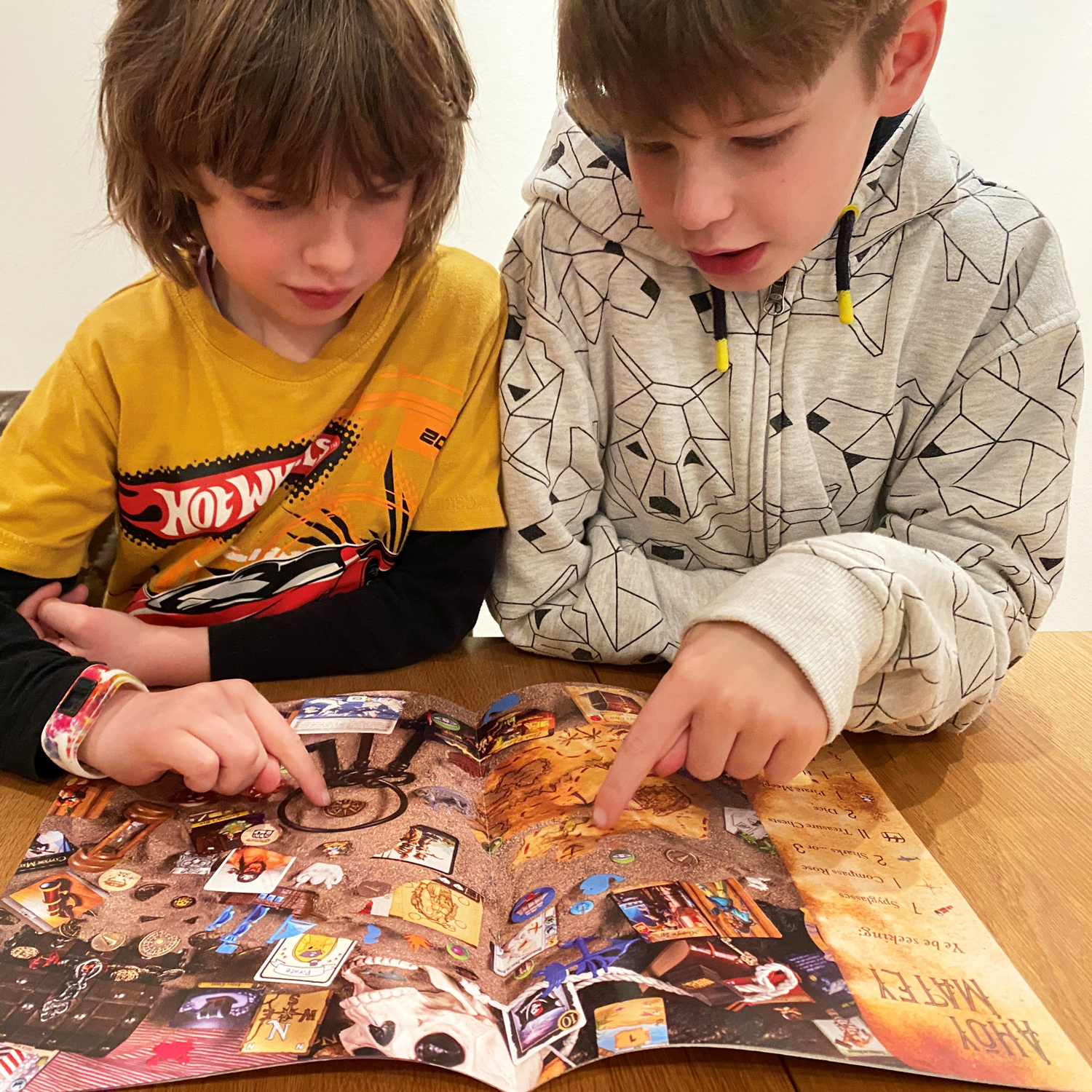 Max and George enjoying the bookImage © Board Game Review UK