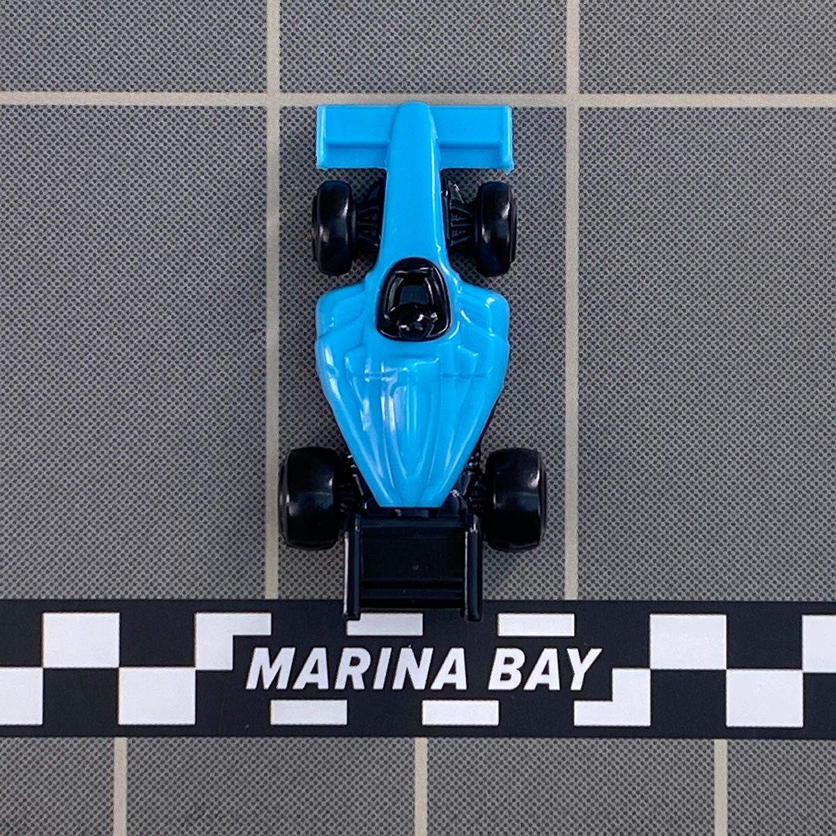 Downforce Blue Car crossing the finish line